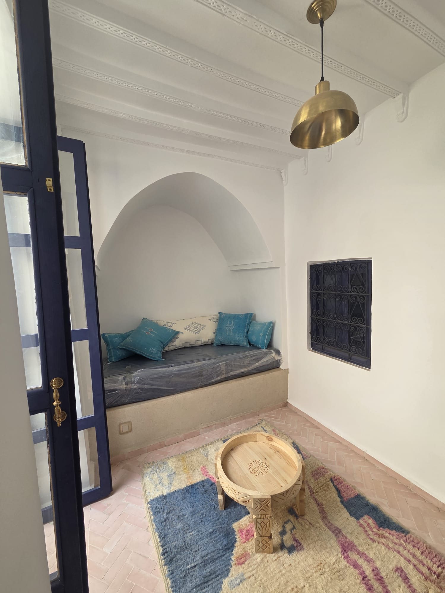 Petit salon en alcôve de la suite, banquette et coussins bleus